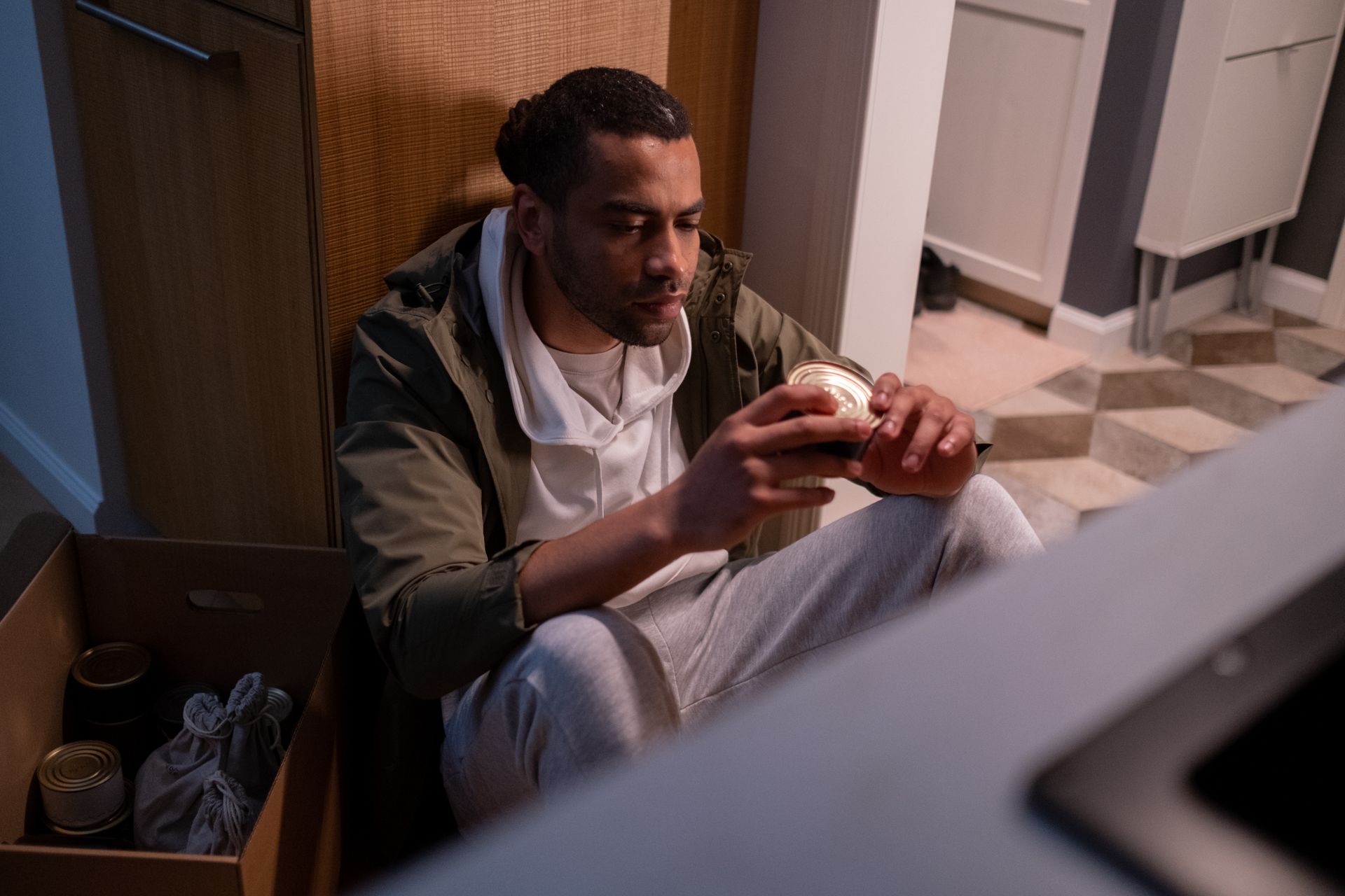 Man Looking at a Canned Food