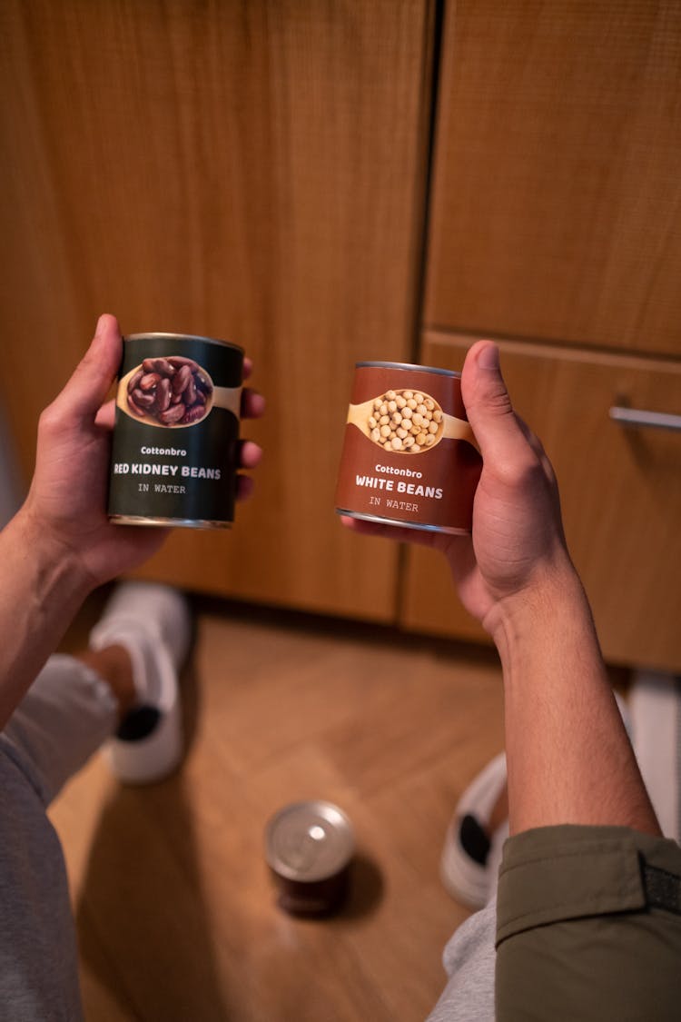 A Person Holding Canned Beans