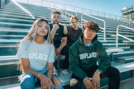 College Students Sitting on Bleachers