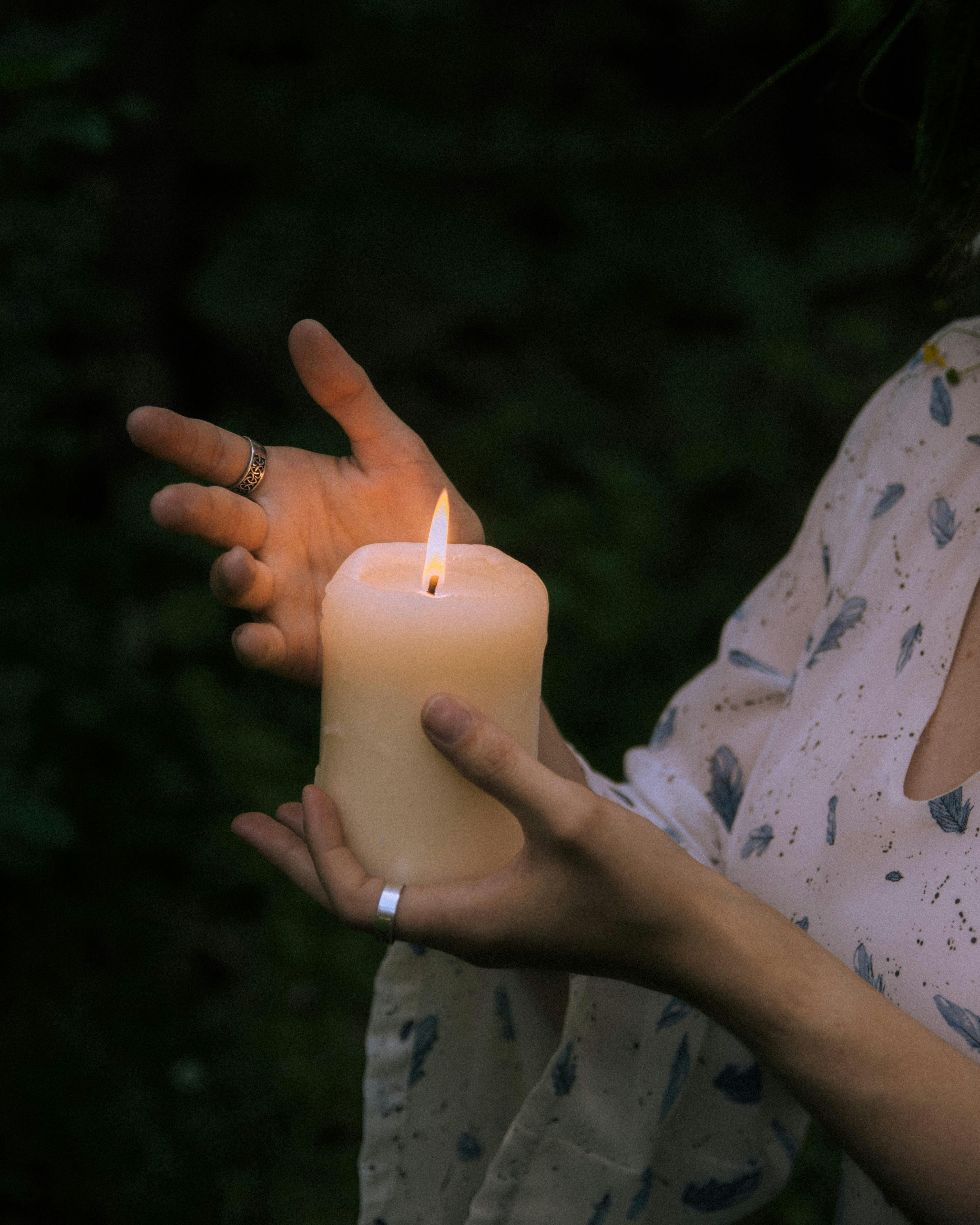 close up view of woman holding candle in hand