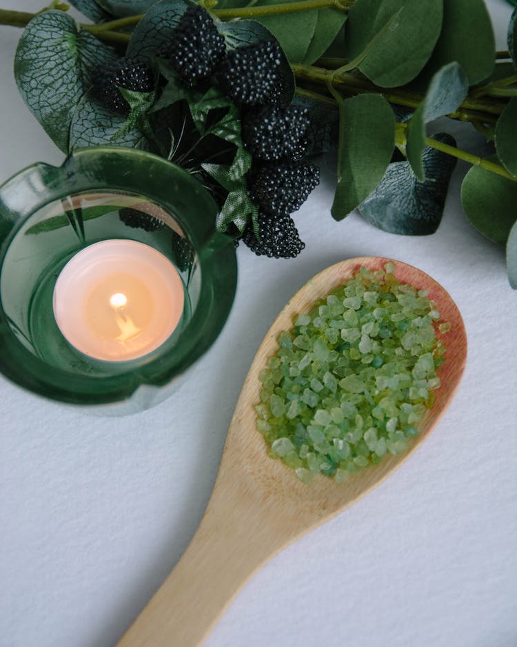 Directly Above View Of Candle And Salt On Wooden Spoon