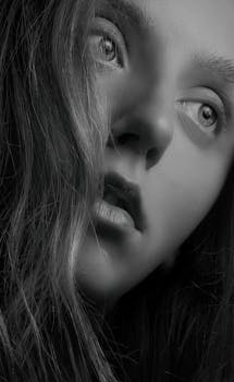 Striking monochrome close-up portrait capturing intense emotion and captivating gaze.