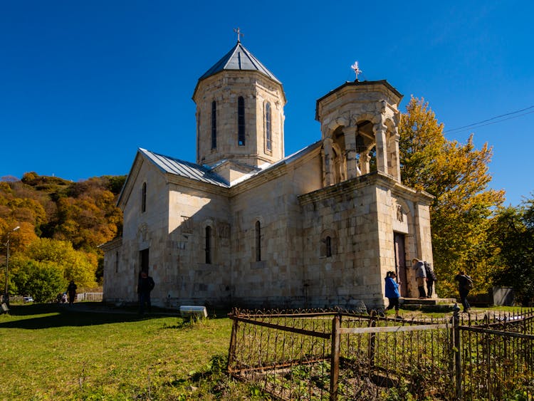 People Entering A Concrete Church