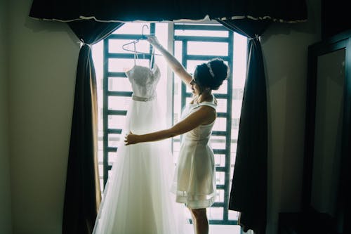 Free A Woman Looking a Wedding Dress Stock Photo
