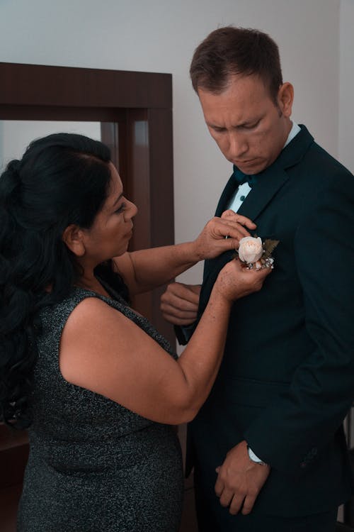 Free A Mature Woman Pinning the Rose on the Groom's Suit Stock Photo