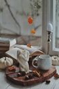 Figurine, Mug, Book and Candle by Window