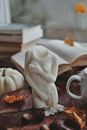 White Figurine on Wooden Tray