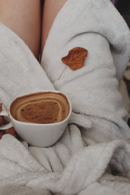 Woman in Bathrobe Holding Cup of Coffee