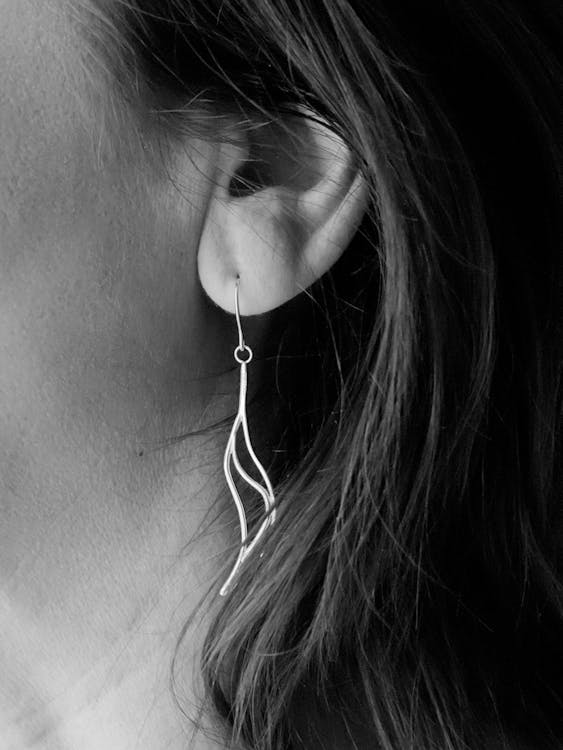Grayscale Photo of Woman's Hook Earrings