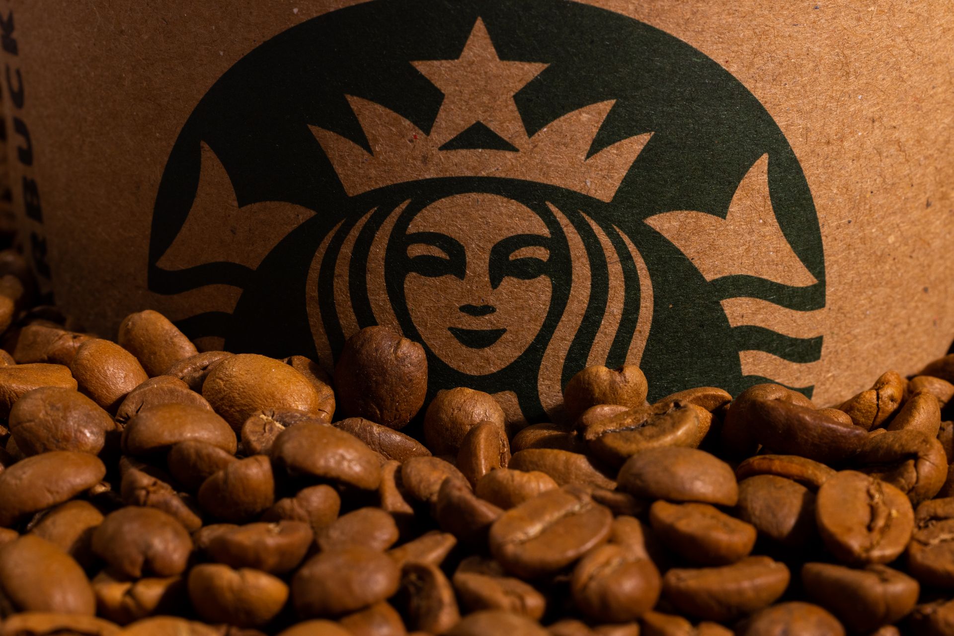 Photo of Brown Coffee Beans Beside a Starbucks Logo
