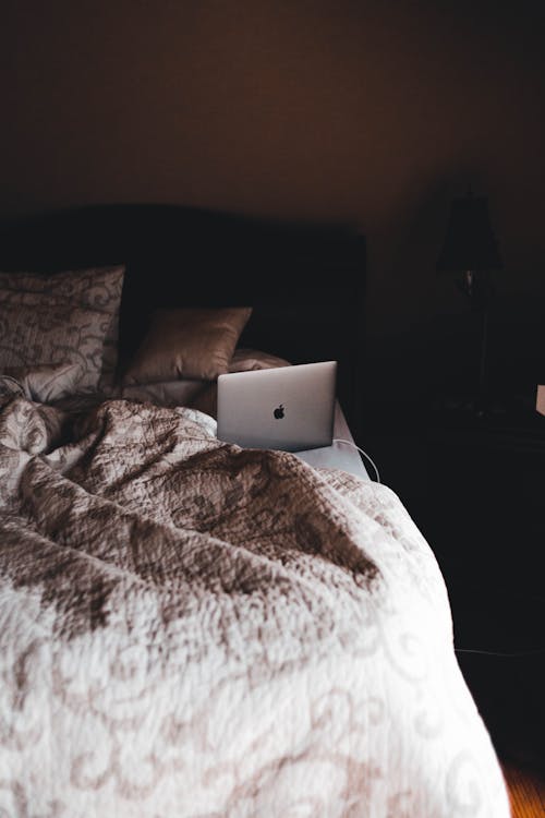 Free Laptop on Bed Stock Photo