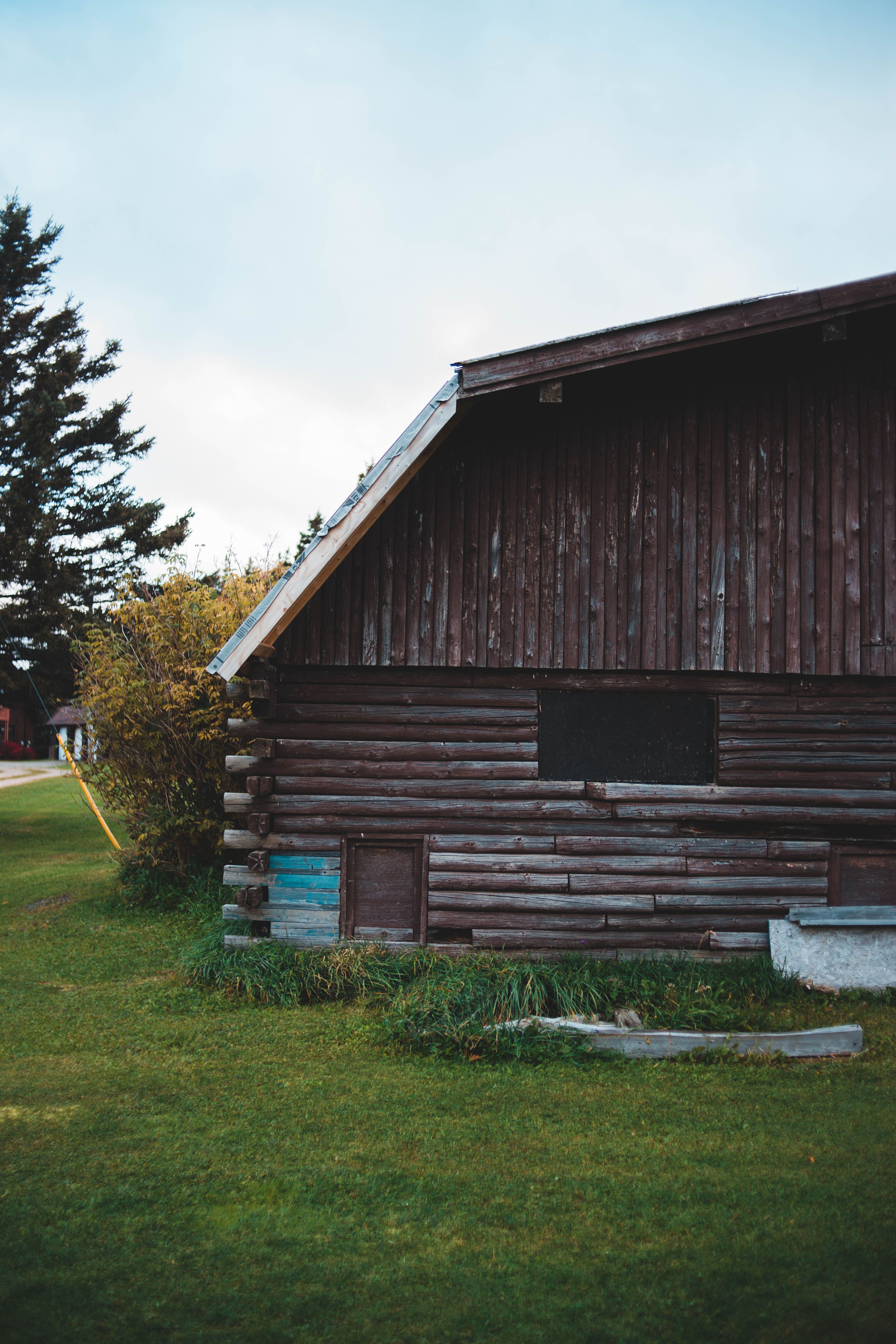 Brown Wooden House on Green Grass Field · Free Stock Photo