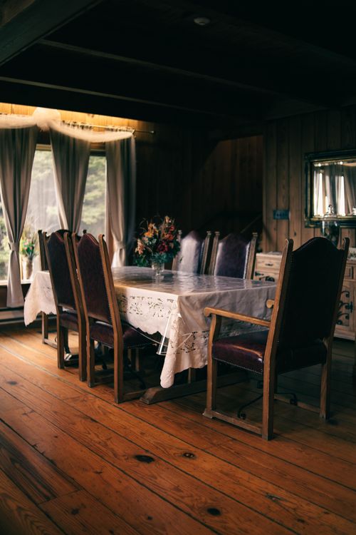 Dark timber dining room — photo by Erik Mclean on Pexels