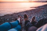 Couples Legs on Shore during Dawn