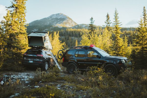 Vehicle-mounted rooftop tent at a campsite