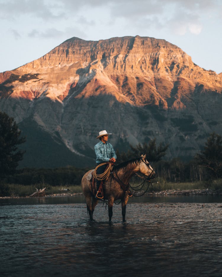 Cowboy Riding A Horse On The River