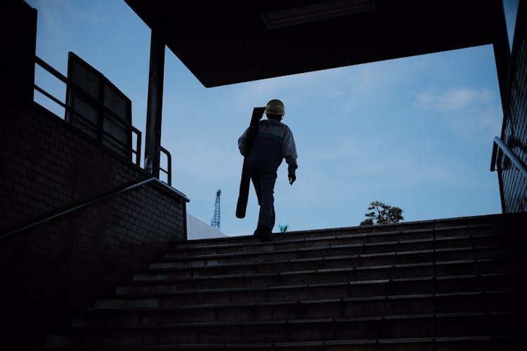 Man Wearing Hardhat Walking On The Stairs