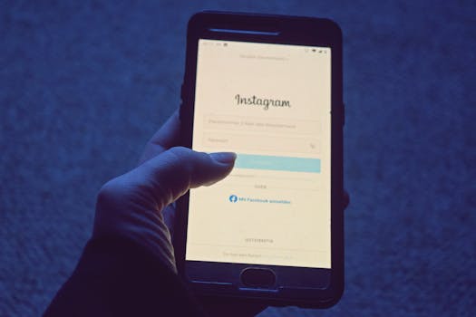 Close-up of a hand holding a smartphone displaying the Instagram login screen.