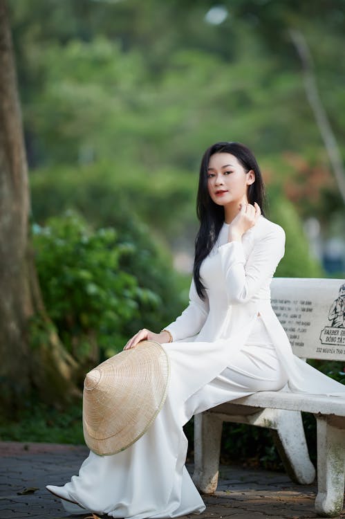 Woman in White Dress Sitting on Bench · Free Stock Photo