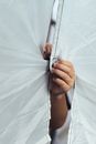 Two Hands Fastening Edges of White Textile with Velcro