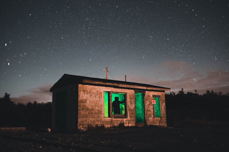 Small Building With Green Light At Night