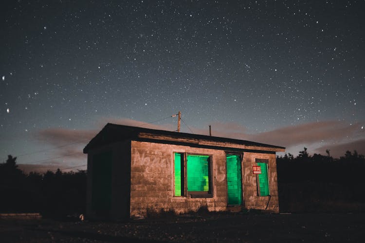 Small Building With Green Light At Night