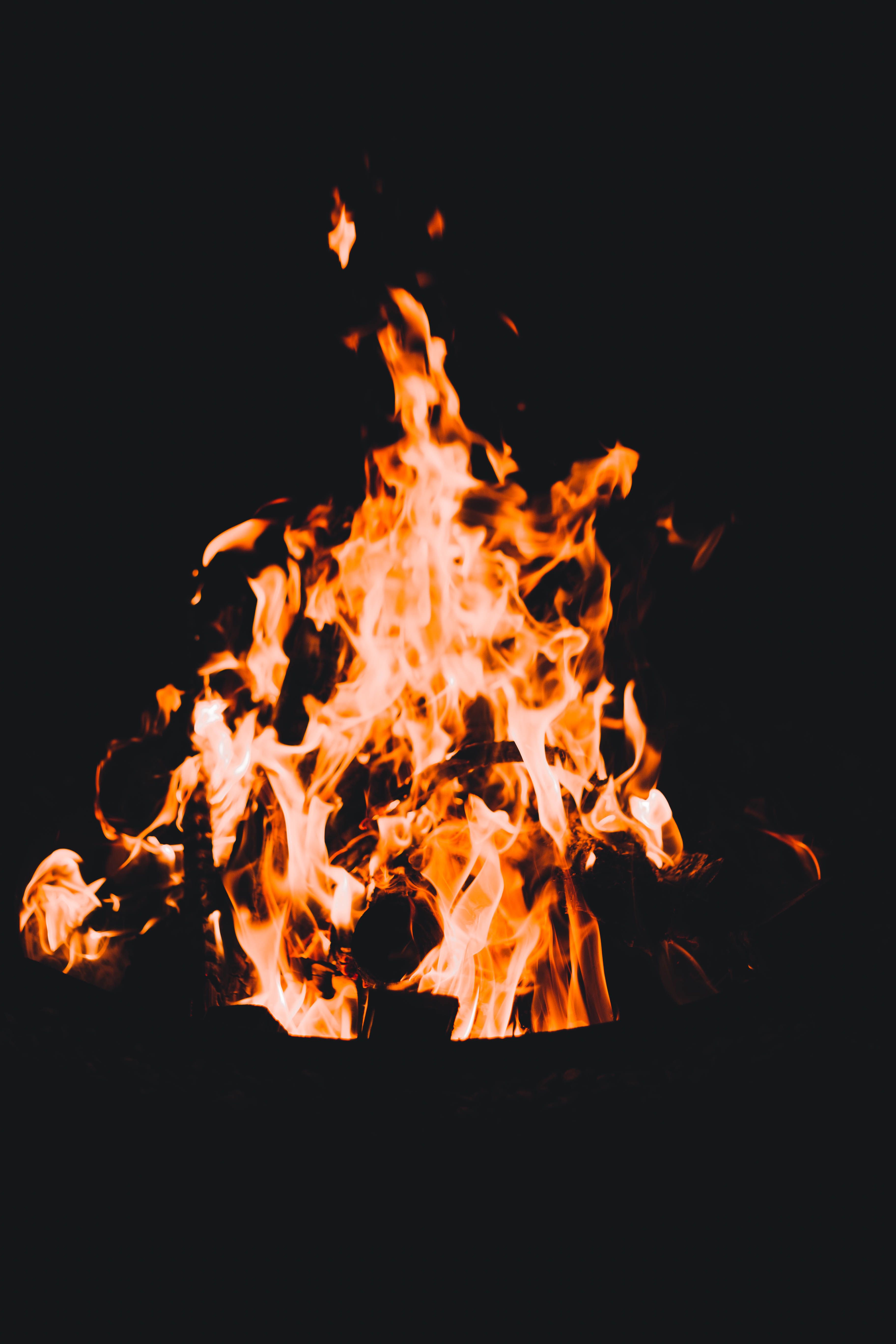 A fire pit with flames in the dark · Free Stock Photo