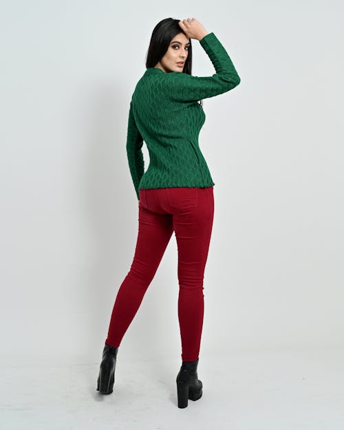 A Woman in Green Coat and Red Pants