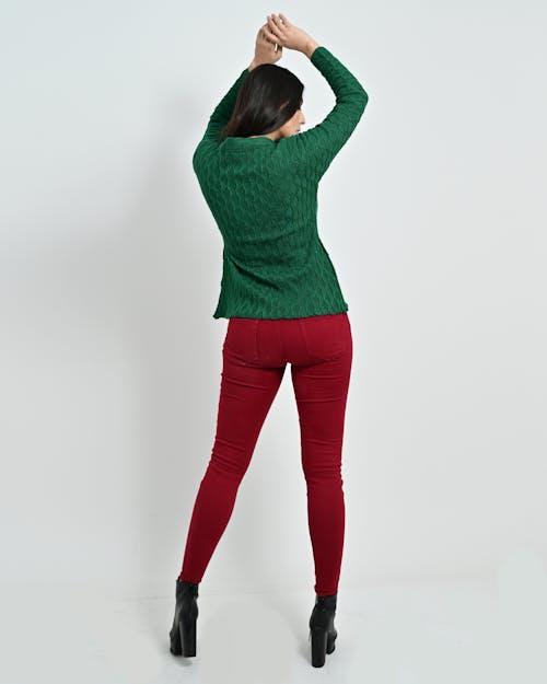 Woman Wearing a Green Top and Red Pants