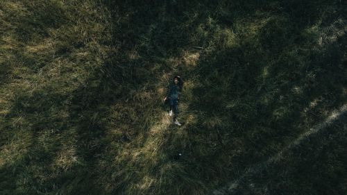 Free Aerial shot of a man lying on grass in India, capturing serene outdoor vibes. Stock Photo