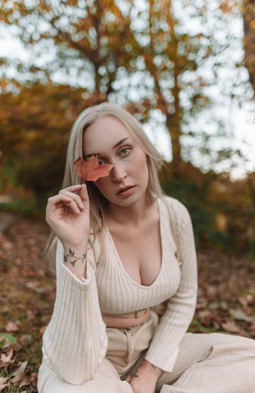 Portrait of Sitting Woman Holding Leaf in Hand