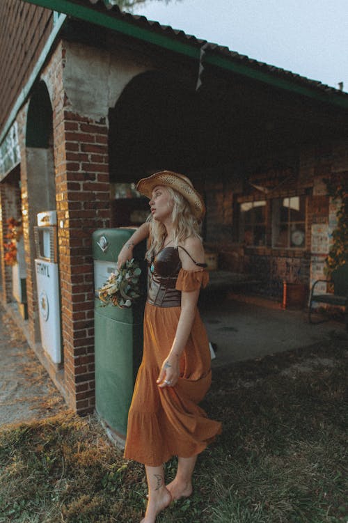 Portrait of Woman in Hat Standing on Grass