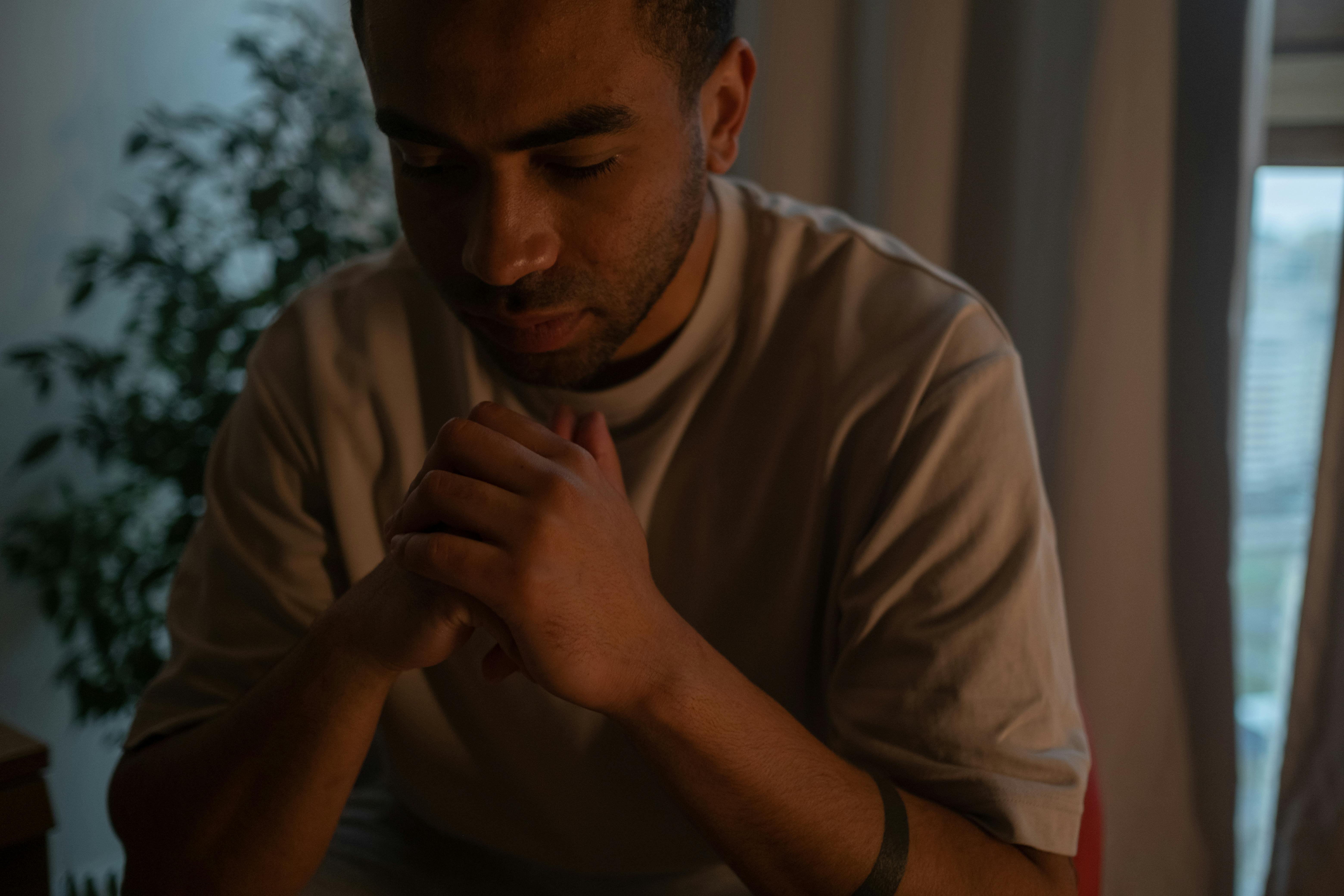 man sitting at home with hands crossed