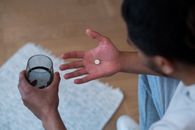 Man Taking a Pill