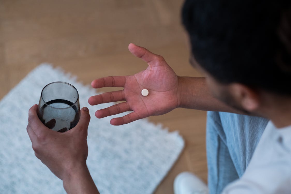 Free Man Taking a Pill Stock Photo