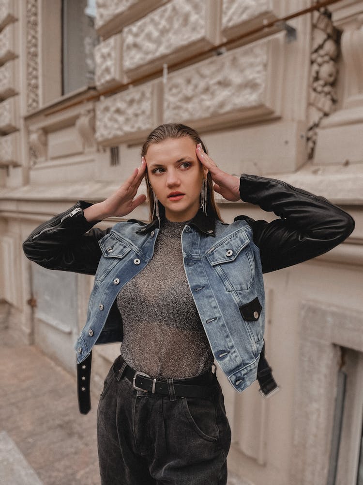 Fashion Female Model Wearing Jeans And Leather Jacket Standing At Old Building Facade