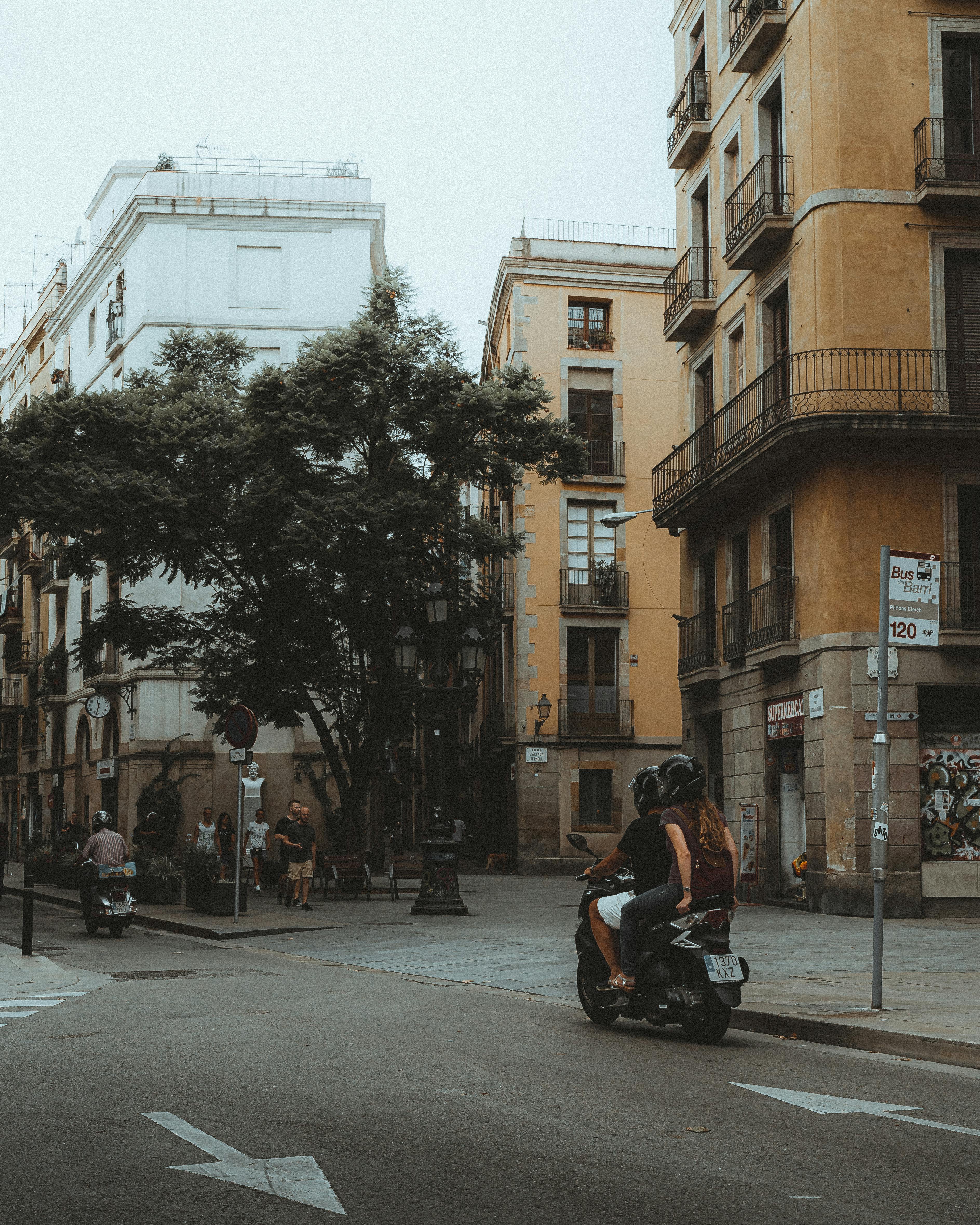 people riding motorcycles and people walking on a street