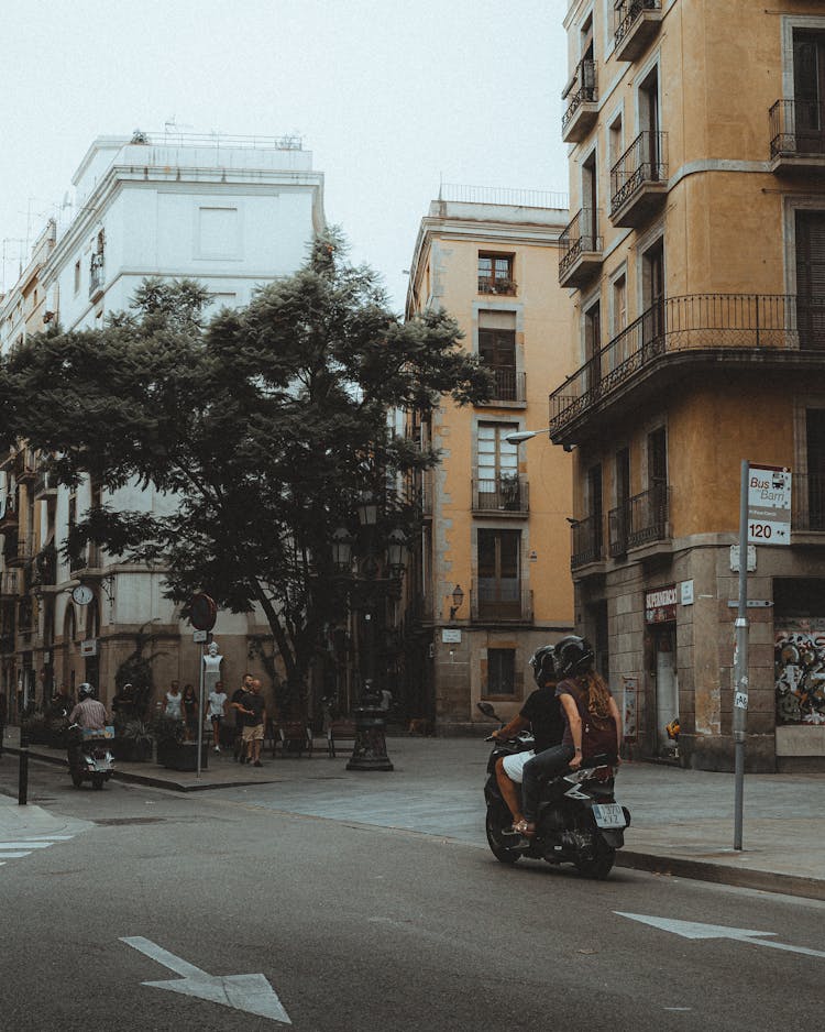 People Riding Motorcycles And People Walking On A Street