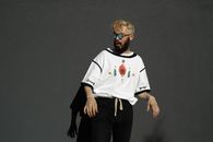 A Bearded Man with Cut Out Paper Flowers on Eyeglasses