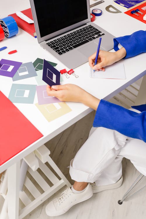 High Angle View of Woman Writing on Paper