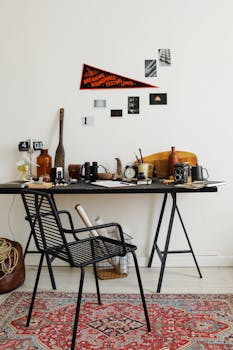 Stylish home office setup with vintage cameras and decor on a black desk.