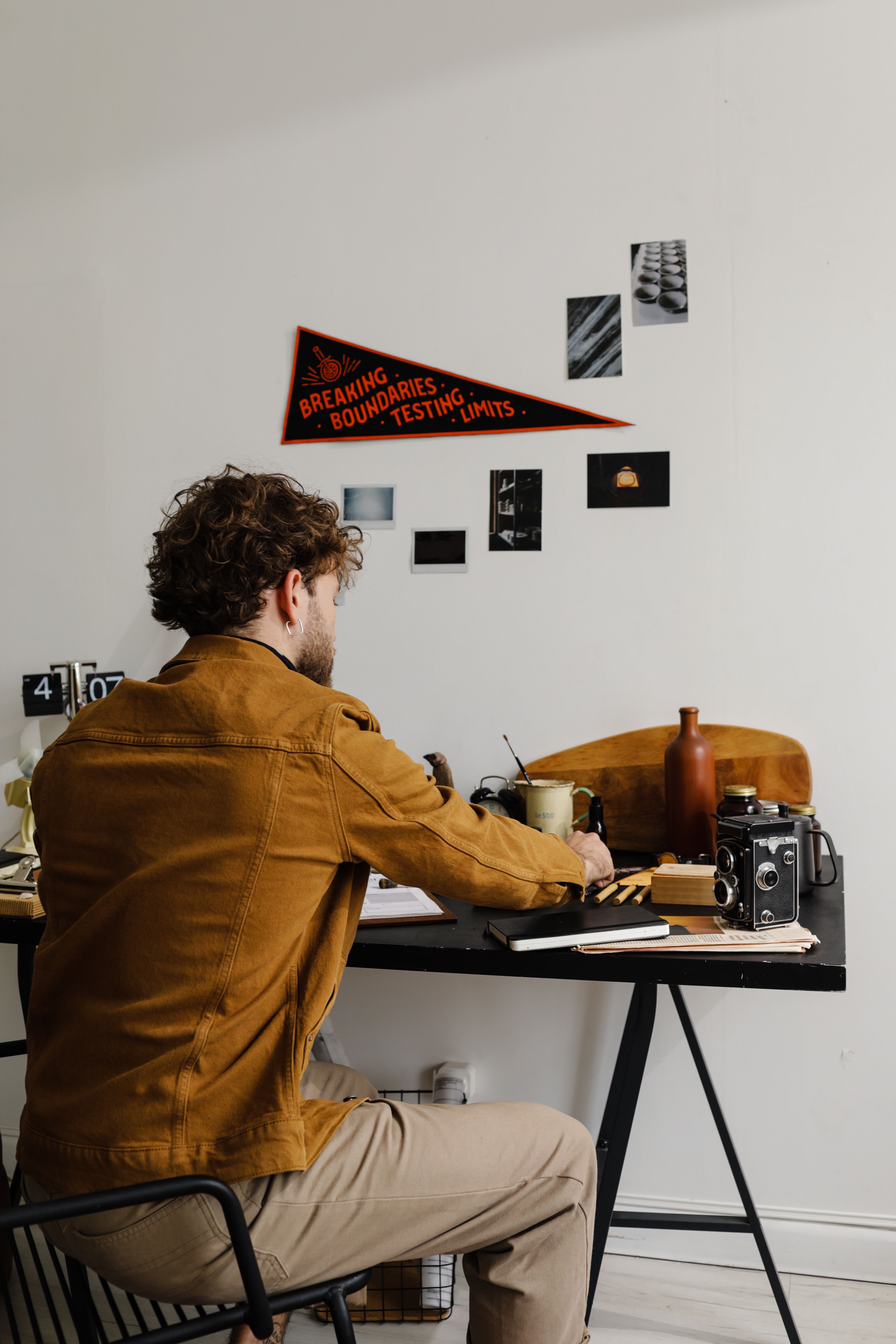 The Saddle Field Jacket in warm brown, worn in a minimal workspace