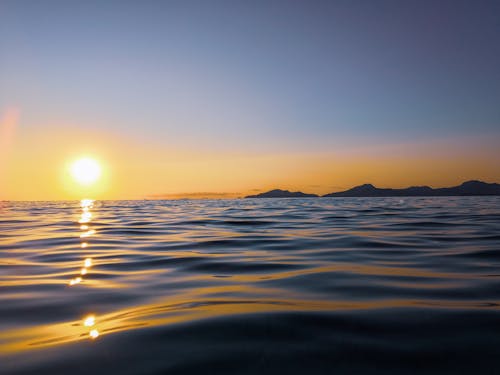 Close-up Photo of Seawater during Sunset 