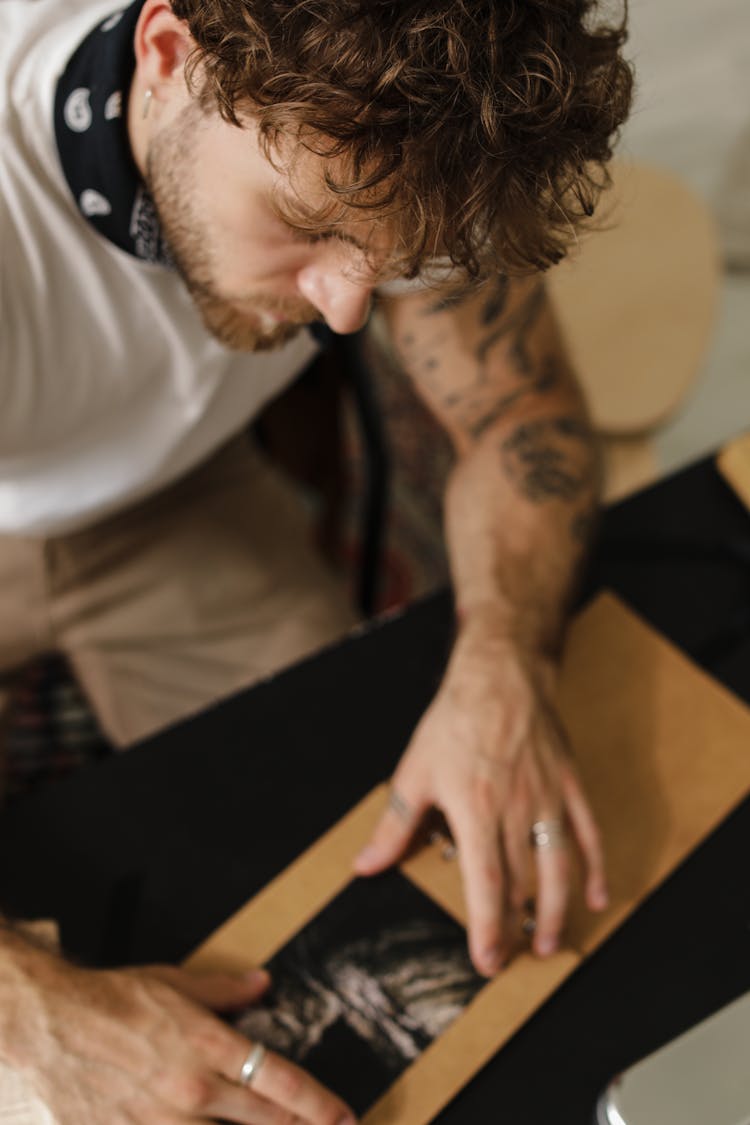 High Angle Shot Of Man Unboxing A Package 