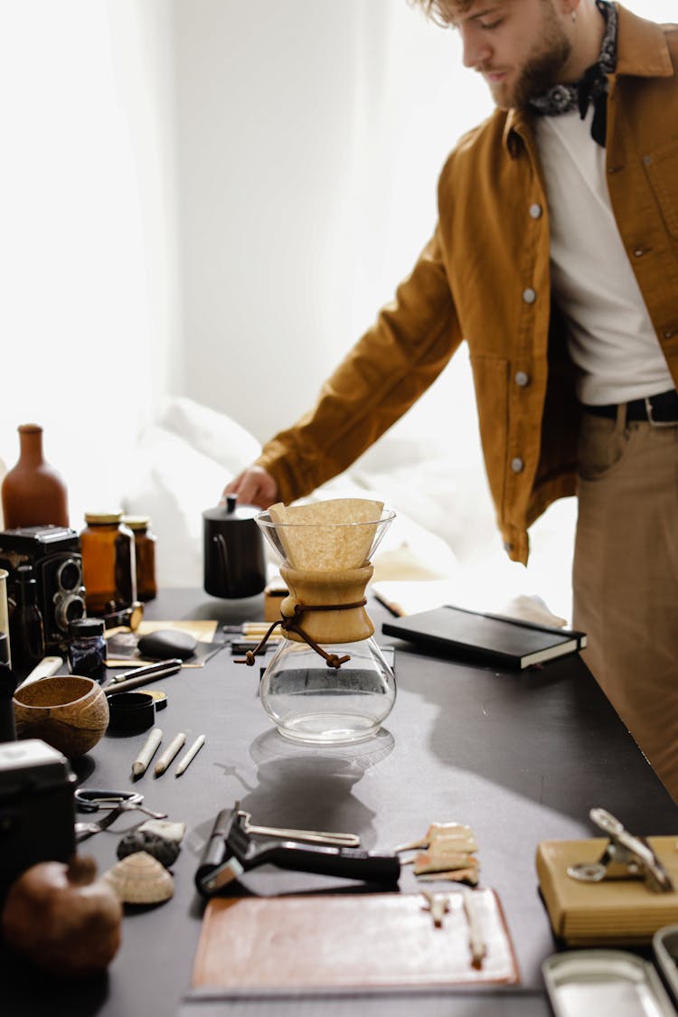 Bearded Man Holding A Black Coffee Pot