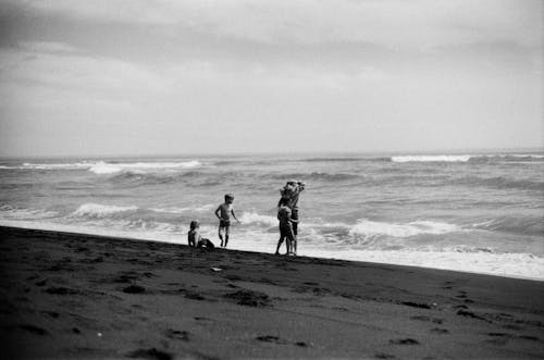Grayscale Photo of People at the Beach