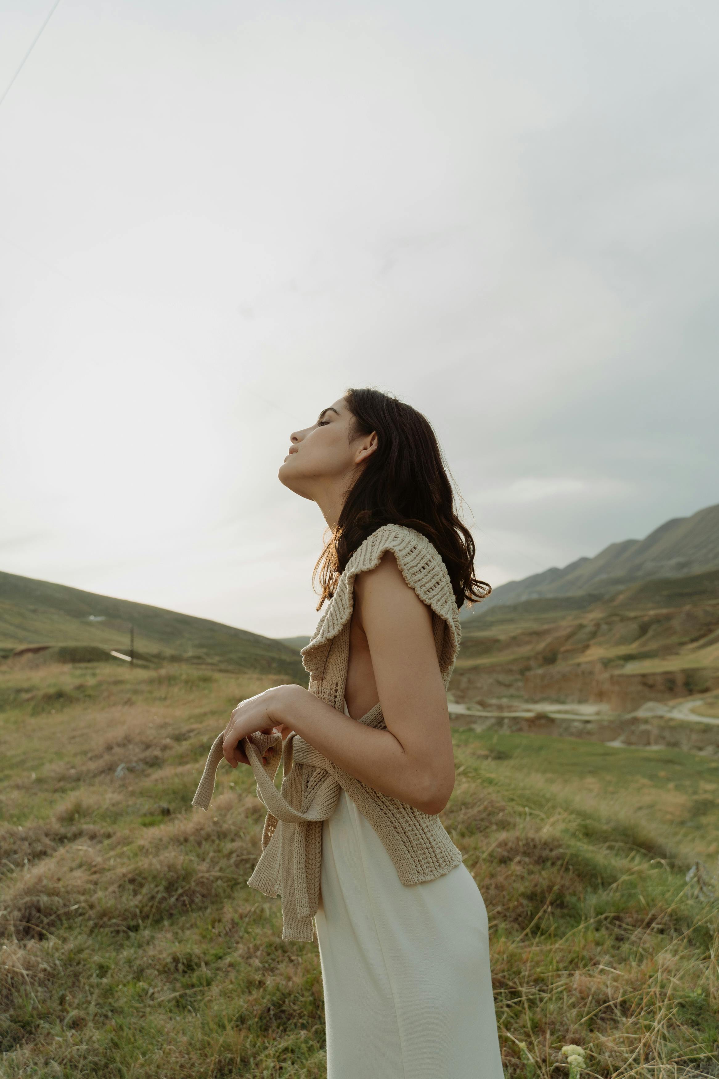 a woman standing on the grass field