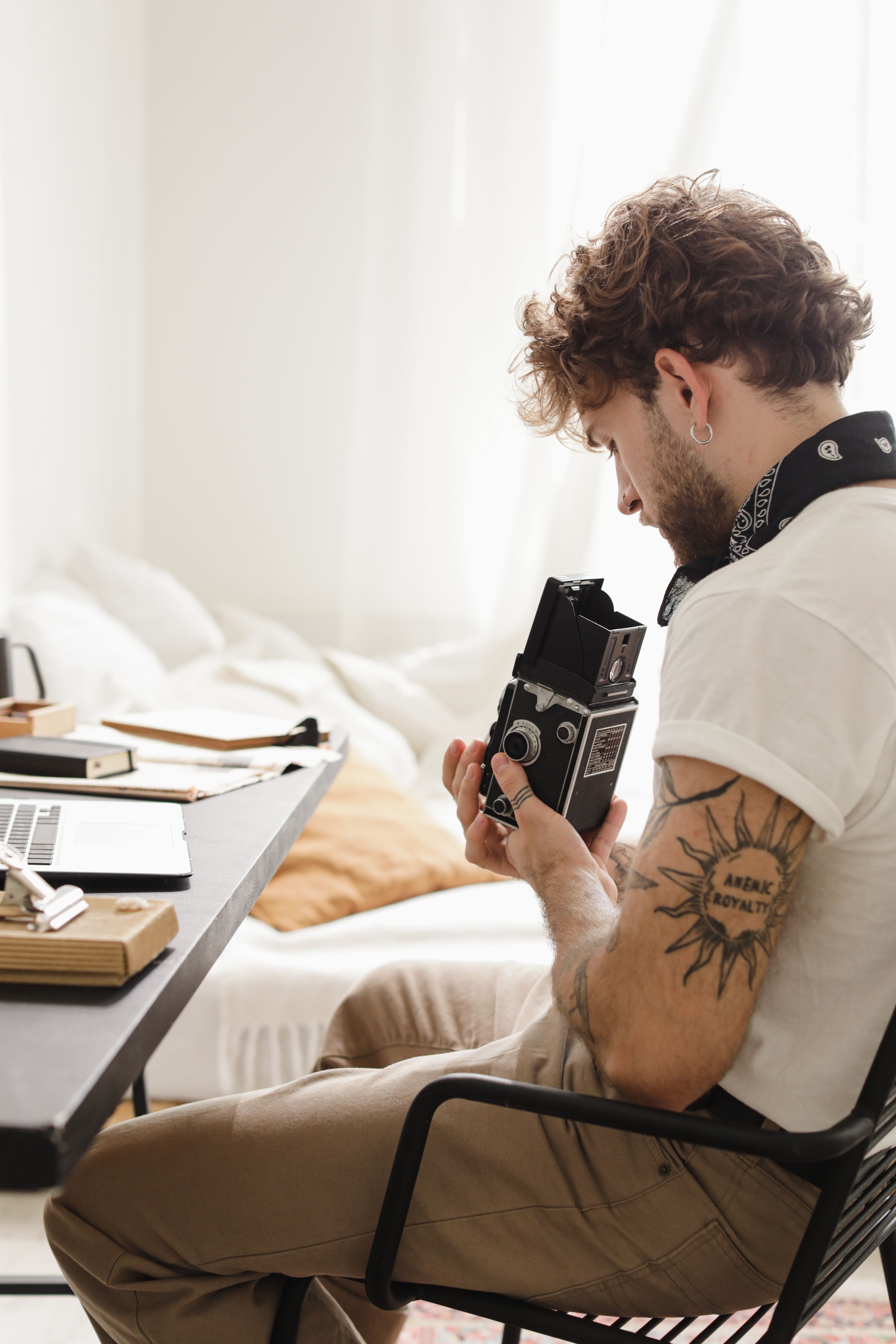 A Man Inspecting a Vintage Camera · Free Stock Photo