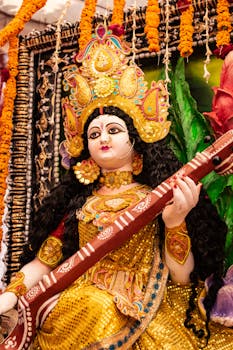 Vibrant image of Goddess Saraswati statue during a Hindu festival adorned with traditional decorations.
