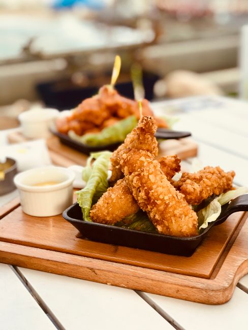 crispy fried chicken pieces in cast iron skillet